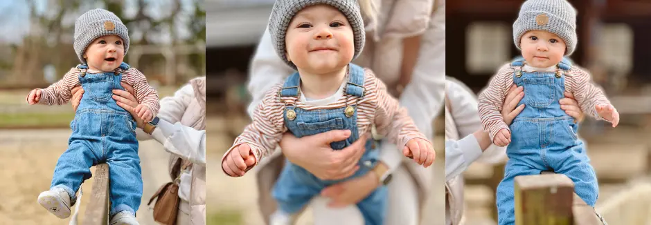Ein Kind mit kuscheliger Mütze und Latzhose wird von einem lächelnden Erwachsenen gehalten, mit einem unscharfen Hintergrund einer warmen Außenlandschaft. Ein Kind mit kuscheliger Mütze und Latzhose wird von einem lächelnden Erwachsenen gehalten, mit einem unscharfen Hintergrund einer warmen Außenlandschaft.