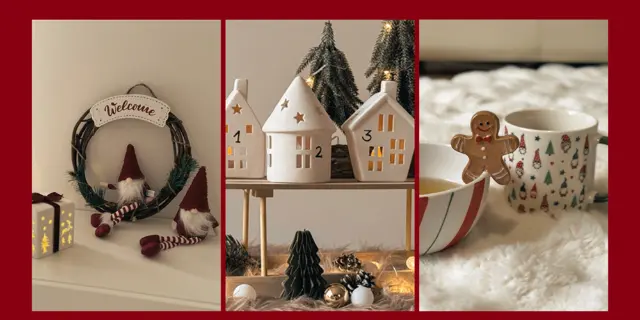 Gemütliche Weihnachtsdekoration mit einem Willkommens-Kranz, charmanten Keramikhäuschen und festlichen Leckereien auf einem flauschigen weißen Teppich.